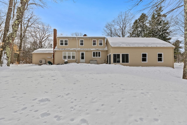 snow covered house with a chimney