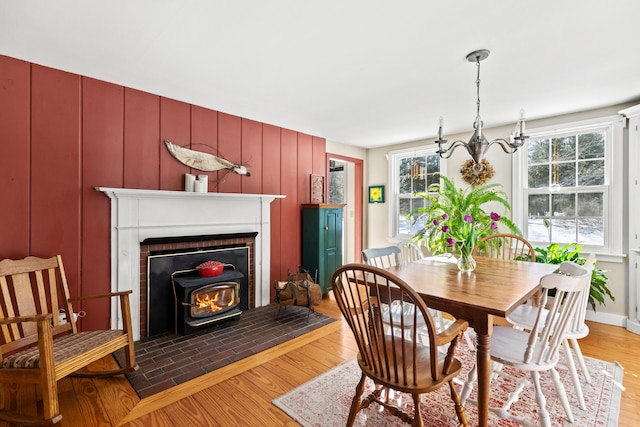 dining space featuring light wood-style floors, a chandelier, and a healthy amount of sunlight