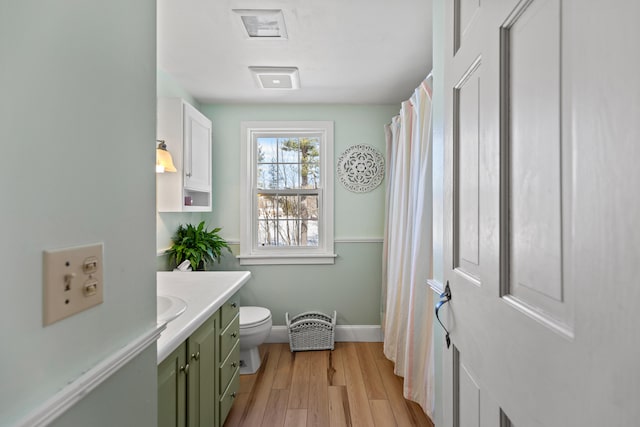 full bathroom featuring vanity, wood finished floors, toilet, and baseboards