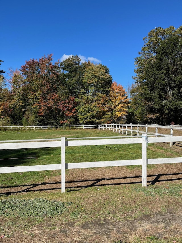 view of yard featuring a rural view and fence