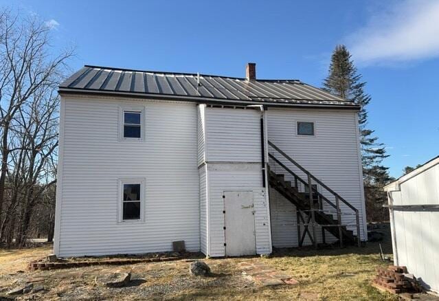 back of house with a lawn