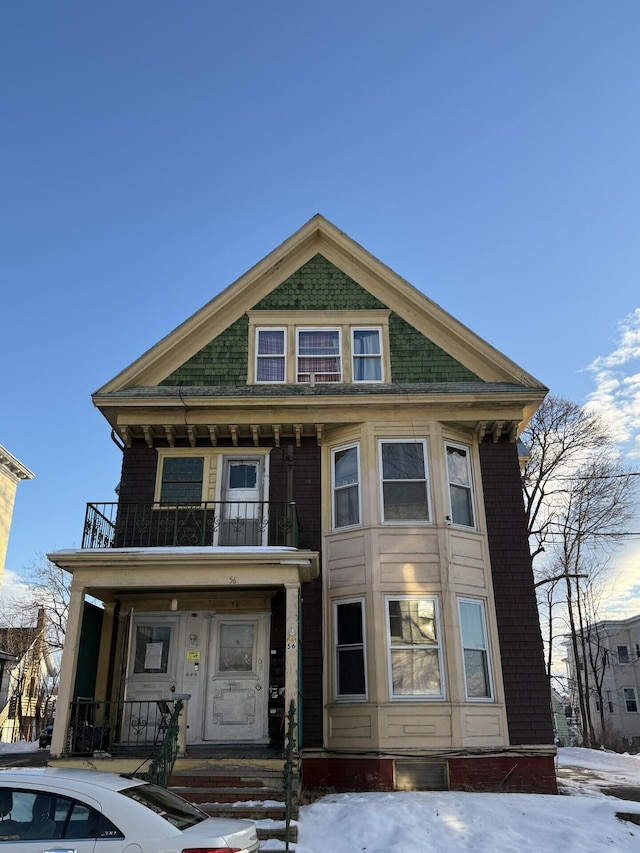 view of front facade featuring a balcony and a porch