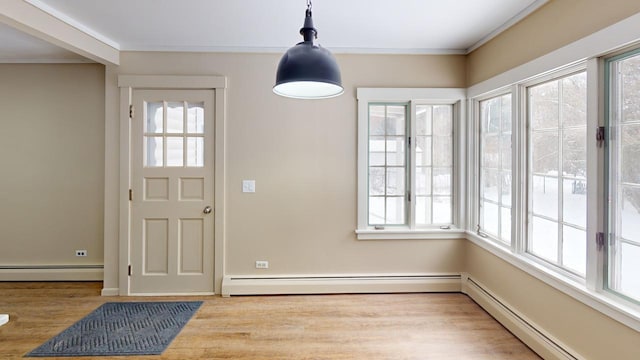 interior space with a baseboard radiator, crown molding, and wood finished floors