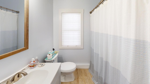 full bathroom with curtained shower, vanity, toilet, and wood finished floors