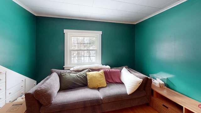 bedroom featuring crown molding and wood finished floors