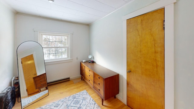 interior space featuring light wood finished floors and a baseboard radiator