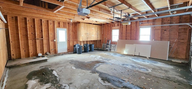 miscellaneous room featuring a garage and a wealth of natural light