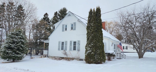 view of snowy exterior featuring fence