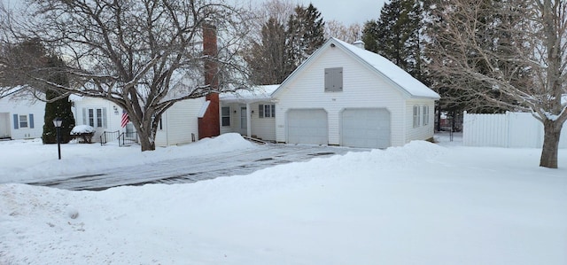 view of front of home with an attached garage and fence