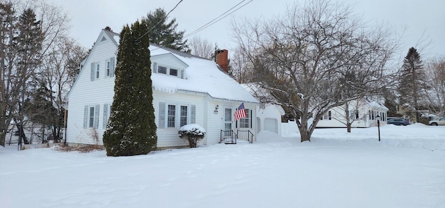 view of front of house with a garage and a chimney