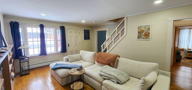 living area with baseboard heating, recessed lighting, wood finished floors, and crown molding