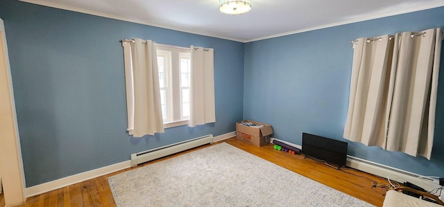 unfurnished room featuring a baseboard radiator, baseboards, and wood finished floors