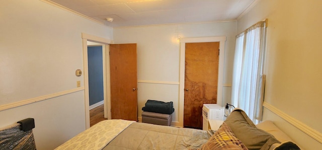 bedroom featuring ornamental molding and multiple windows