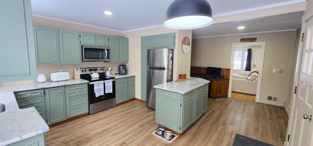 kitchen featuring green cabinets, visible vents, stainless steel appliances, and ornamental molding