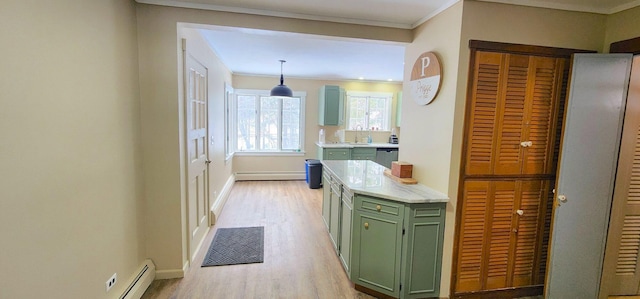 kitchen featuring light wood finished floors, a baseboard radiator, light countertops, green cabinetry, and baseboards