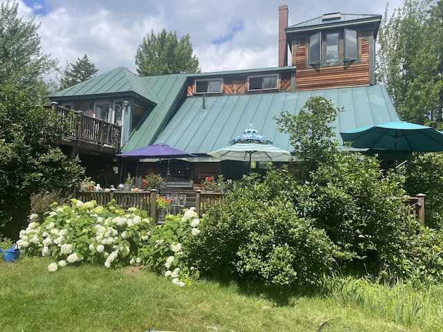 exterior space featuring a deck and a lawn