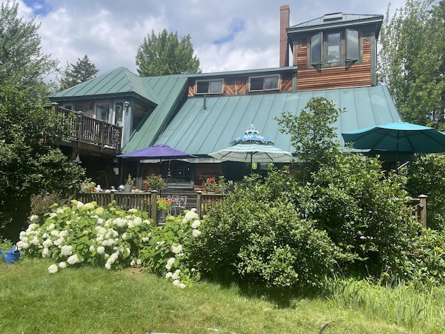 exterior space featuring a deck and a lawn