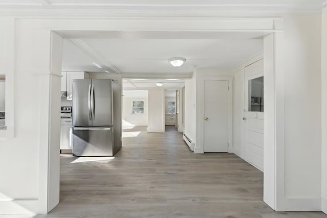 hallway with light wood-type flooring and a baseboard heating unit