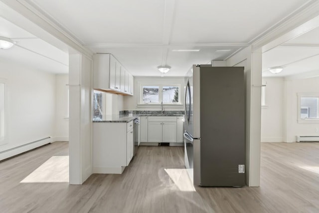 kitchen featuring white cabinets, a baseboard radiator, stainless steel appliances, and a sink