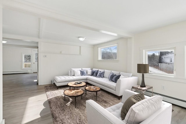 living area with a baseboard radiator, a baseboard heating unit, and wood finished floors