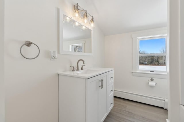 bathroom featuring vanity, baseboard heating, and wood finished floors