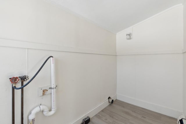 laundry room featuring laundry area, washer hookup, light wood-type flooring, and a baseboard radiator