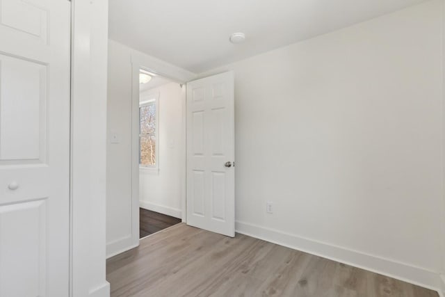 interior space featuring light wood finished floors and baseboards