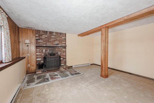 unfurnished living room featuring a wood stove, a baseboard radiator, light carpet, and a textured ceiling