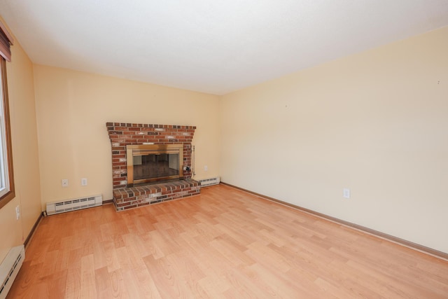 unfurnished living room with light wood-style floors, a fireplace, and baseboard heating