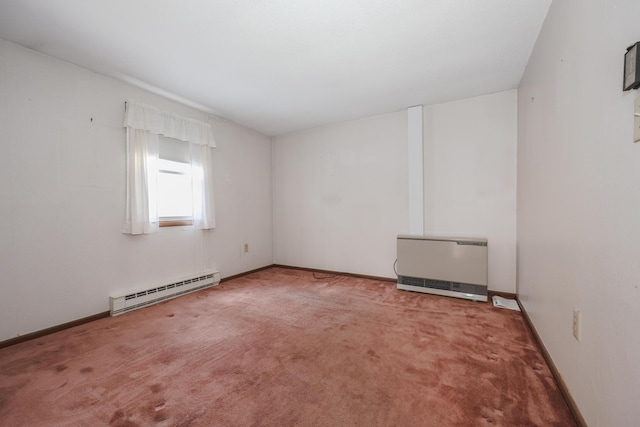 carpeted spare room featuring a baseboard heating unit, baseboards, and heating unit