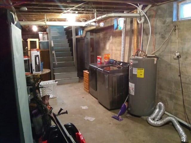 basement featuring water heater and washer and dryer