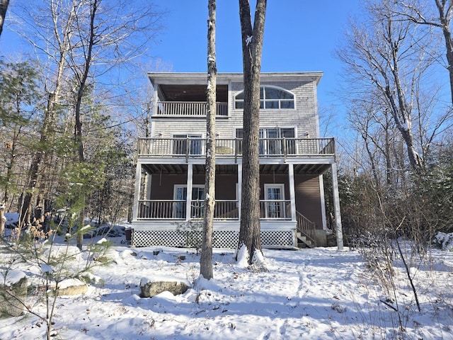 view of front of property featuring a porch and a balcony