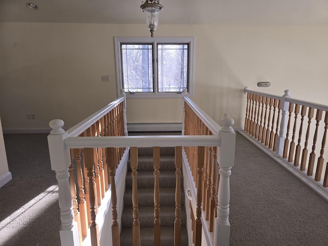 stairway featuring a baseboard radiator and carpet flooring