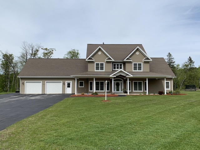 view of front of house with a garage, a front lawn, and a porch