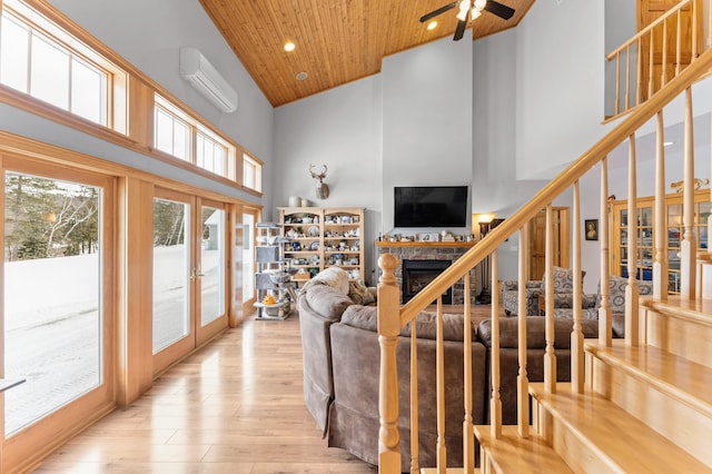 120 Bradbury Rd, Fort Kent, ME 04743 - living room featuring a wall mounted air conditioner, high vaulted ceiling, wooden ceiling, light wood-type flooring, and french doors