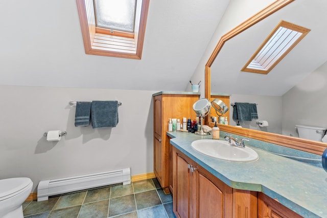 120 Bradbury Rd, Fort Kent, ME 04743 - bathroom featuring vanity, a baseboard radiator, vaulted ceiling with skylight, and toilet