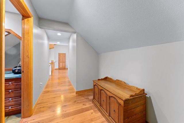 120 Bradbury Rd, Fort Kent, ME 04743 - corridor with lofted ceiling, light hardwood / wood-style flooring, and a textured ceiling