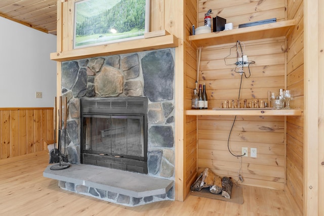 details featuring wood-type flooring, a fireplace, and wood walls