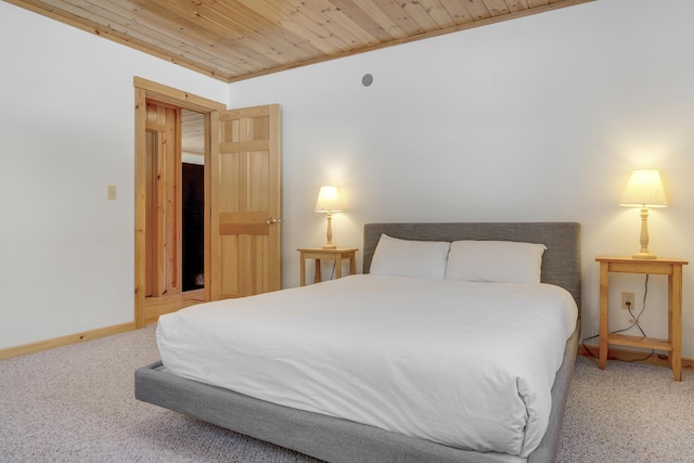 carpeted bedroom with wood ceiling