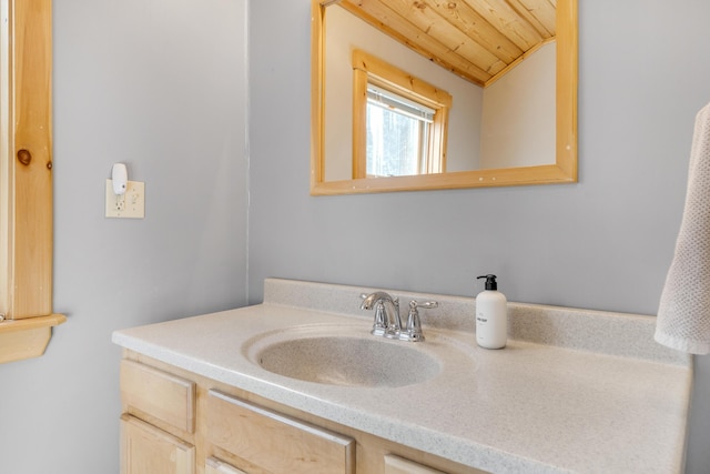 bathroom featuring vanity, wood ceiling, and lofted ceiling