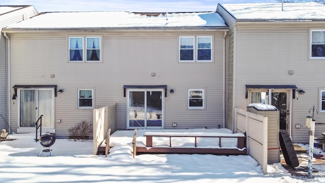 view of snow covered rear of property