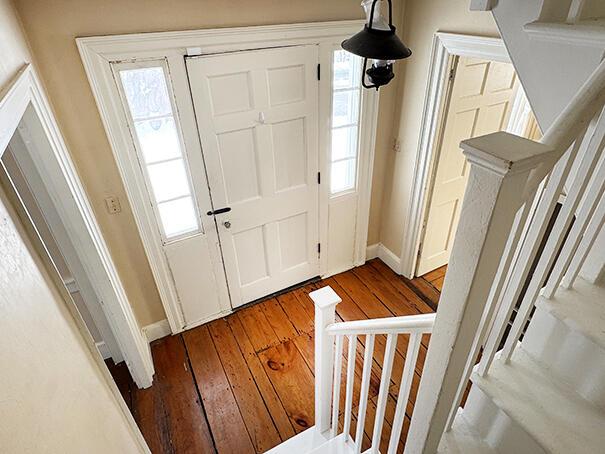 foyer entrance featuring hardwood / wood-style flooring and a wealth of natural light