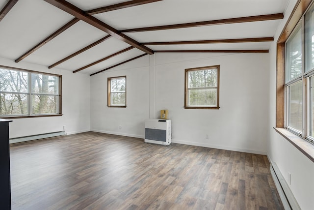 spare room with heating unit, a baseboard heating unit, wood-type flooring, and lofted ceiling with beams