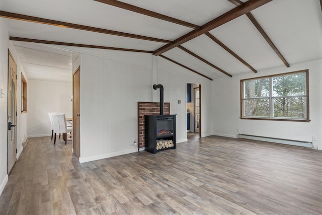 living room with hardwood / wood-style flooring, vaulted ceiling with beams, a wood stove, and a baseboard heating unit