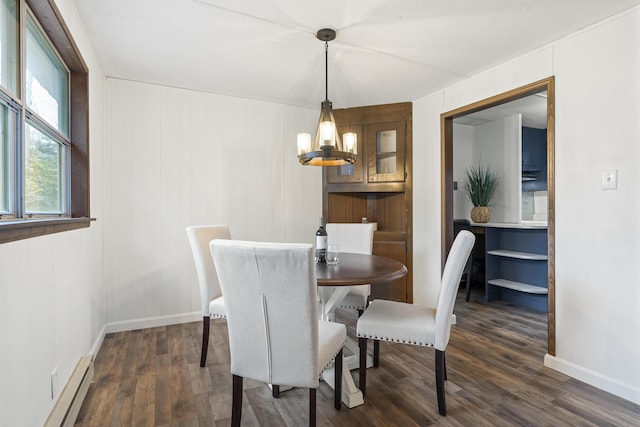 dining area featuring a baseboard radiator, dark hardwood / wood-style flooring, and a notable chandelier