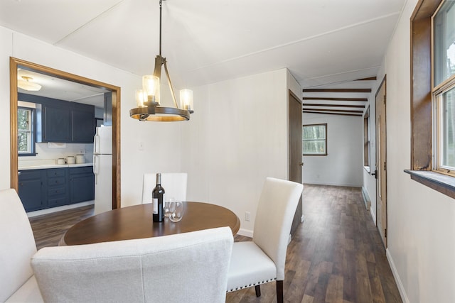 dining space featuring a notable chandelier and dark hardwood / wood-style floors