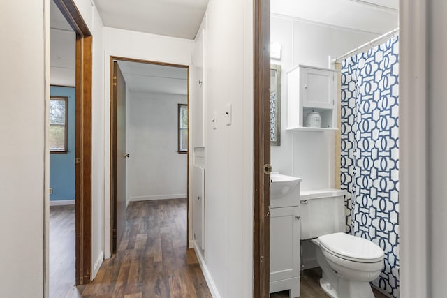 bathroom featuring hardwood / wood-style flooring, vanity, and toilet