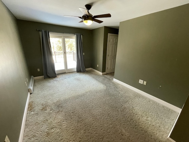 empty room featuring a baseboard radiator, light colored carpet, and ceiling fan