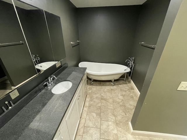 bathroom with vanity, tile patterned floors, and a tub