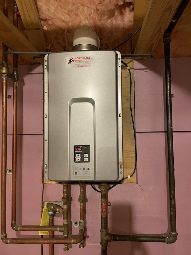 utility room featuring tankless water heater